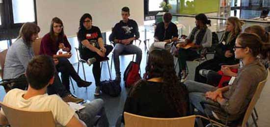A group of students sitting in a circle for a discussion.