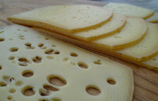 Käsescheiben auf einem Holzbrett.